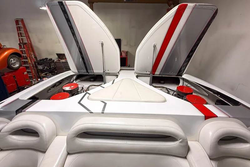 Slide: The Image of 2004 MTI 44 Pleasure Cat boat with open engine hatches in a garage setting. - 7