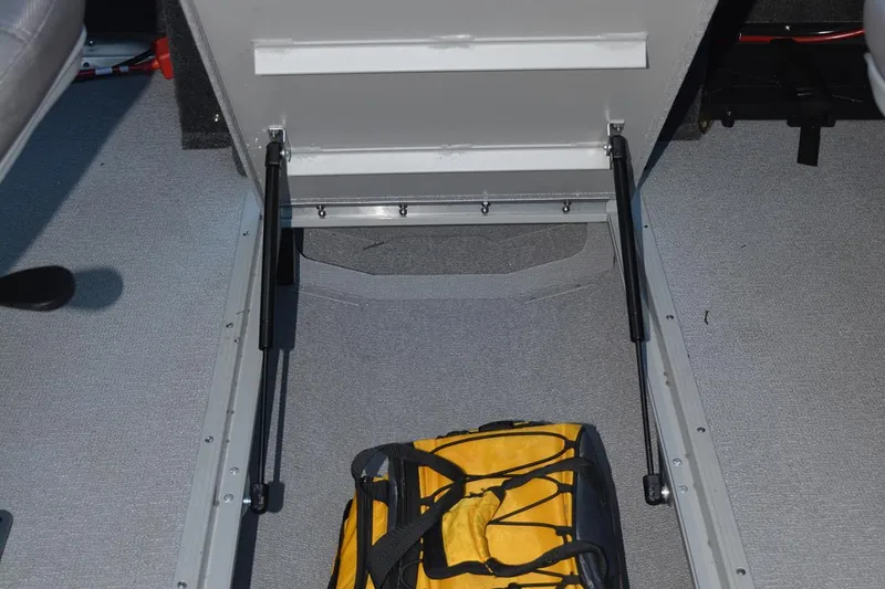 Slide: The Image of Manufacturer Provided Image: Under-seat storage compartment in 2022 Smoker Craft Ultima 182 boat with yellow bag. - 13