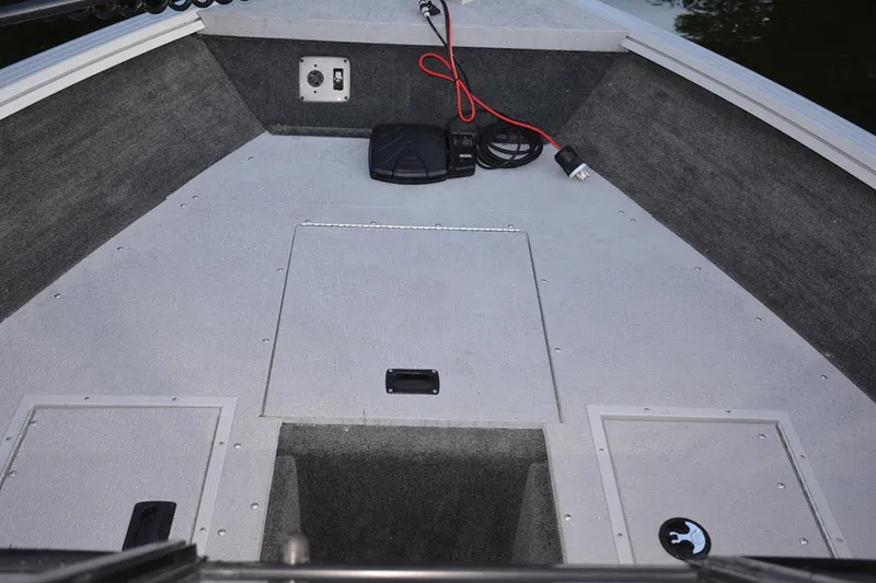 Slide: The Image of Manufacturer Provided Image: 2022 Smoker Craft Ultima 182 boat interior, featuring storage compartments and electrical connections. - 3