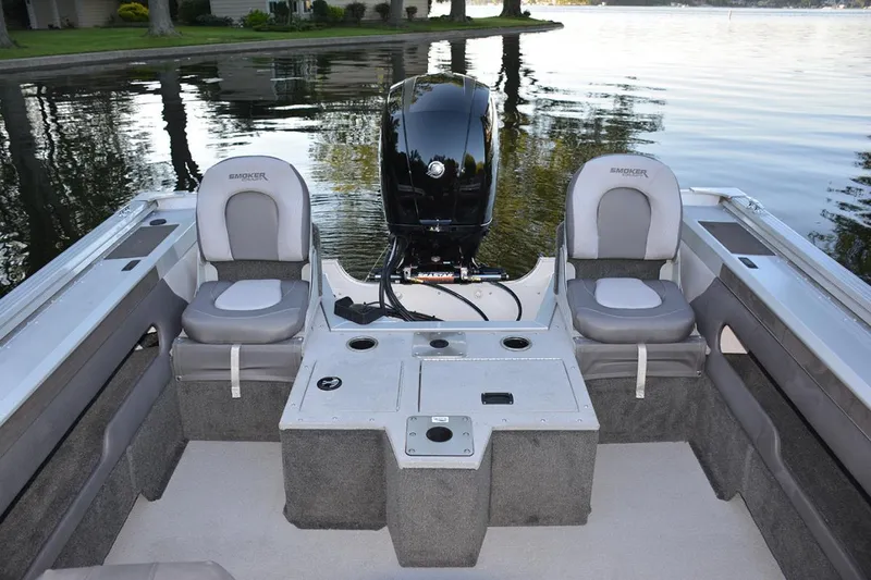 Slide: The Image of Manufacturer Provided Image: 2022 Smoker Craft Ultima 182 boat interior with seating and motor on a calm lake. - 9