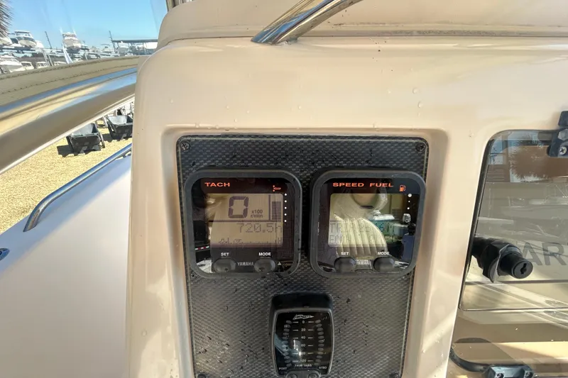Slide: The Image of Dashboard of a 2006 Grady-White Fisherman 222 boat with tachometer and speed fuel gauges. - 19