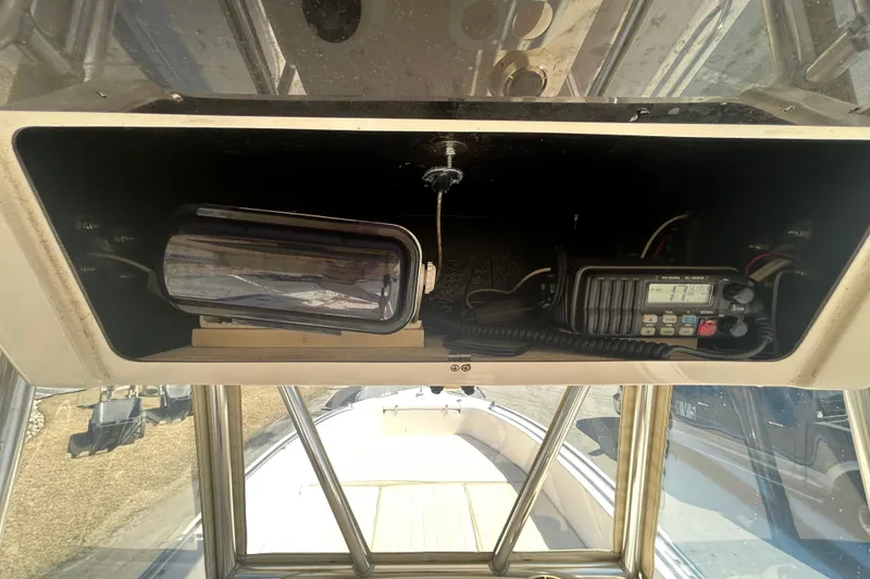 Slide: The Image of 2006 Grady-White Fisherman 222 boat console with radio and spotlight. - 27