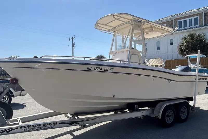Slide: The Image of 2006 Grady-White Fisherman 222 boat on trailer, parked near coastal house. - 3