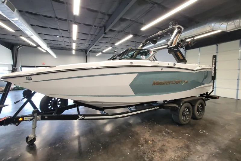 Slide: The Image of 2022 MasterCraft XStar S boat on trailer in showroom setting. - 10