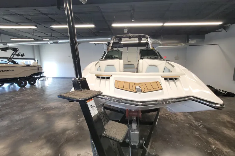 Slide: The Image of 2022 MasterCraft XStar S boat displayed in a showroom, front view. - 11