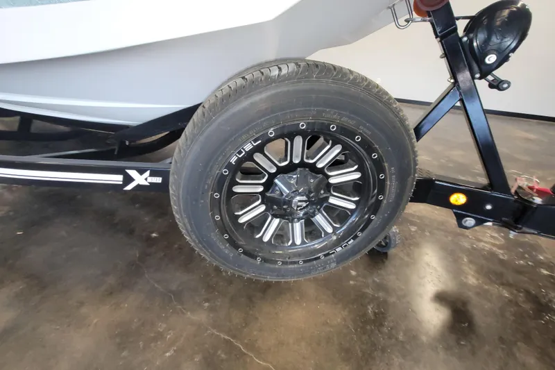 Slide: The Image of 2022 MasterCraft XStar S trailer with Fuel wheel on display. - 12