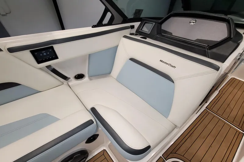 Slide: The Image of 2022 MasterCraft XStar S interior with white and blue seating, modern design, and wood flooring. - 17