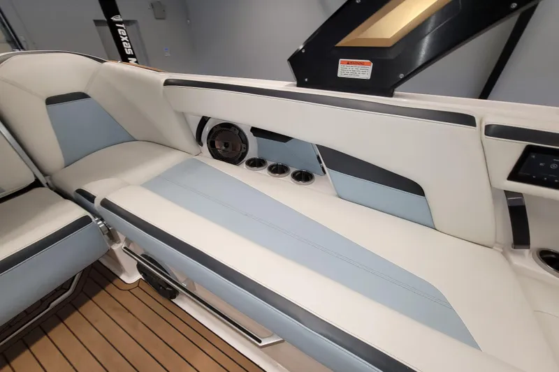 Slide: The Image of 2022 MasterCraft XStar S interior seating with sleek design and integrated speakers. - 18