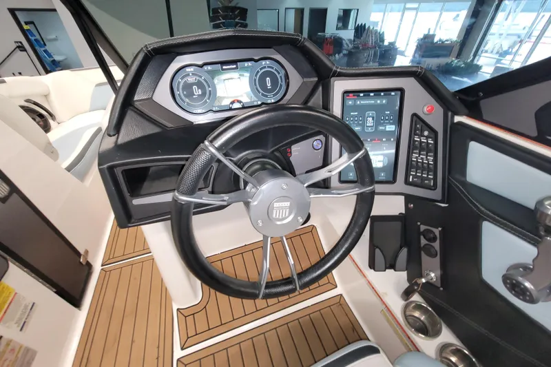 Slide: The Image of 2022 MasterCraft XStar S dashboard with modern controls and steering wheel. - 21