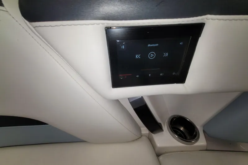 Slide: The Image of 2022 MasterCraft XStar S interior with Bluetooth control panel and cup holder. - 26