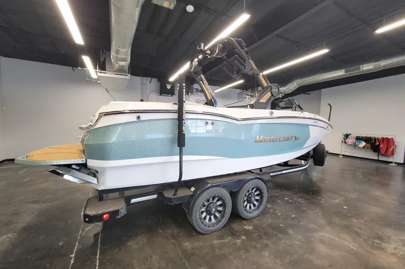 Slide: The Image of 2022 MasterCraft XStar S boat on trailer in showroom setting. - 5