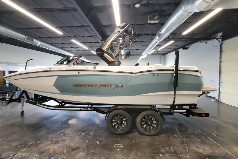 Slide: The Image of 2022 MasterCraft XStar S boat on trailer in showroom, side view. - 9