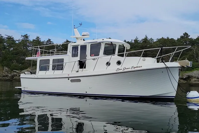 The Image of American Tug 362, 2020 model, anchored in scenic waters with forested background. - 0