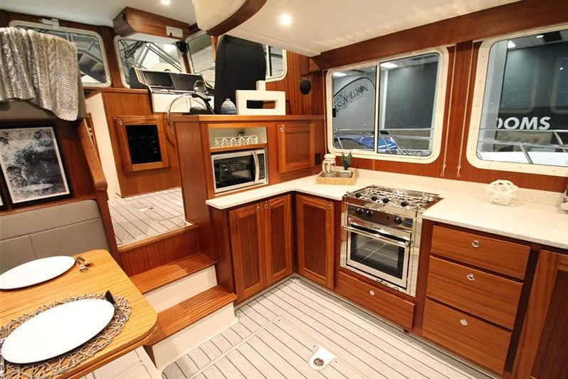 Slide: The Image of Interior of a 2020 American Tug 362, featuring a modern kitchen and dining area. - 12