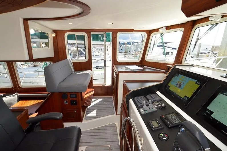 Slide: The Image of Interior of 2020 American Tug 362, featuring modern navigation equipment and comfortable seating. - 17
