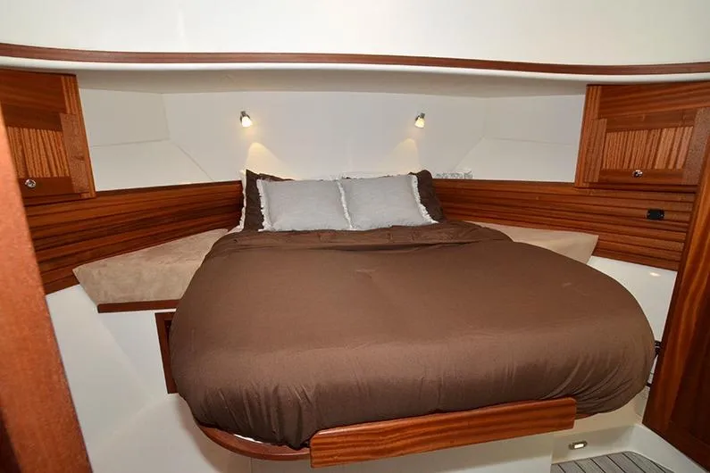 Slide: The Image of Cozy bedroom in 2020 American Tug 362 with wood accents and ambient lighting. - 19
