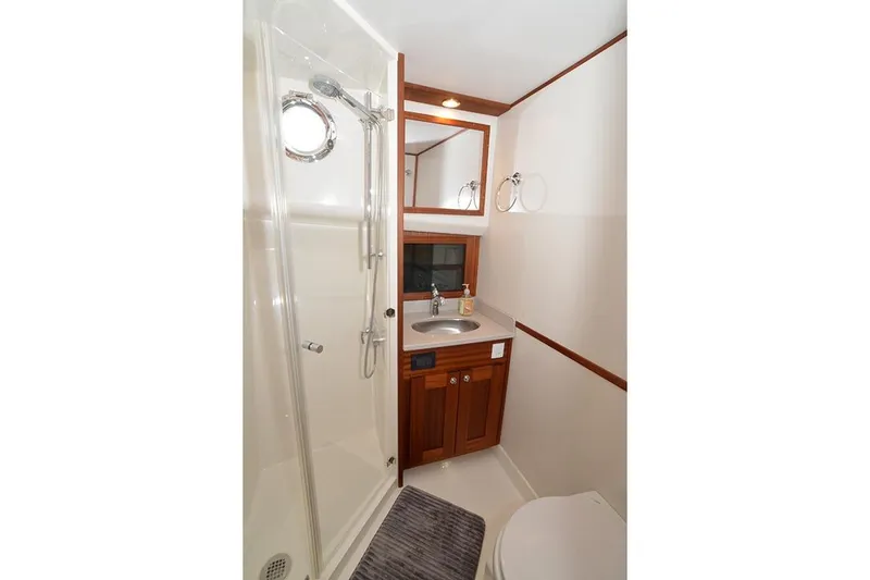 Slide: The Image of Bathroom interior of 2020 American Tug 362 with shower, sink, and wooden cabinetry. - 22