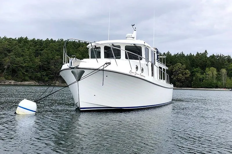 Slide: The Image of 2020 American Tug 362 anchored in scenic waters with forested background. - 5