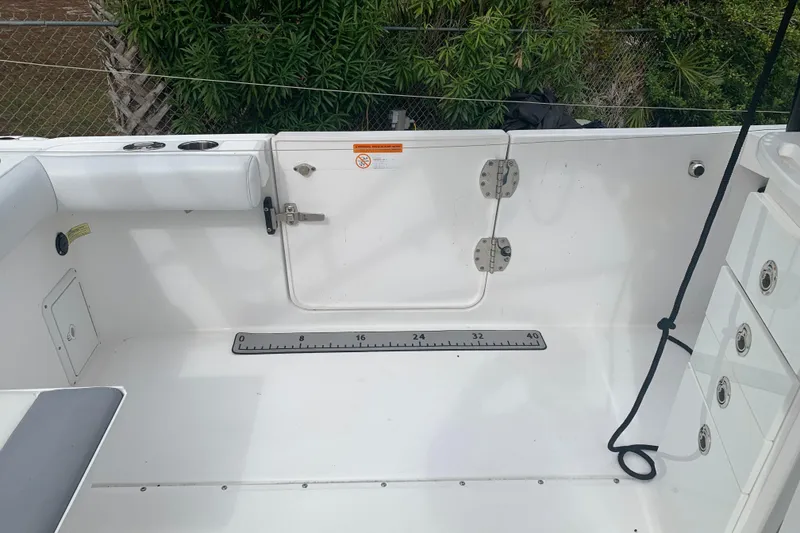 Slide: The Image of 2018 Everglades 355 Center Console boat deck with storage and measurement scale. - 10