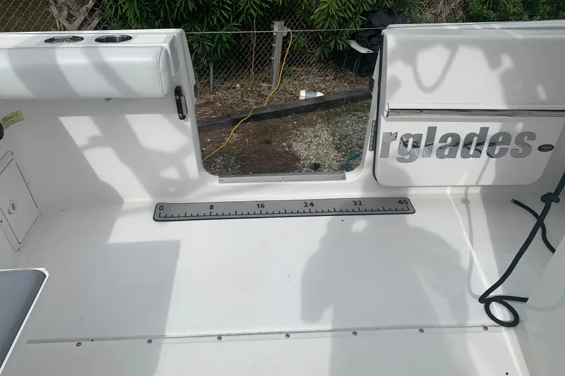 Slide: The Image of 2018 Everglades 355 Center Console boat deck with measuring ruler and seating area. - 11