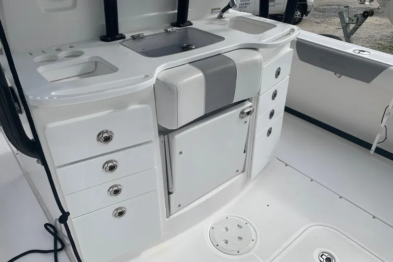 Slide: The Image of 2018 Everglades 355 Center Console boat interior with storage and sink area. - 12