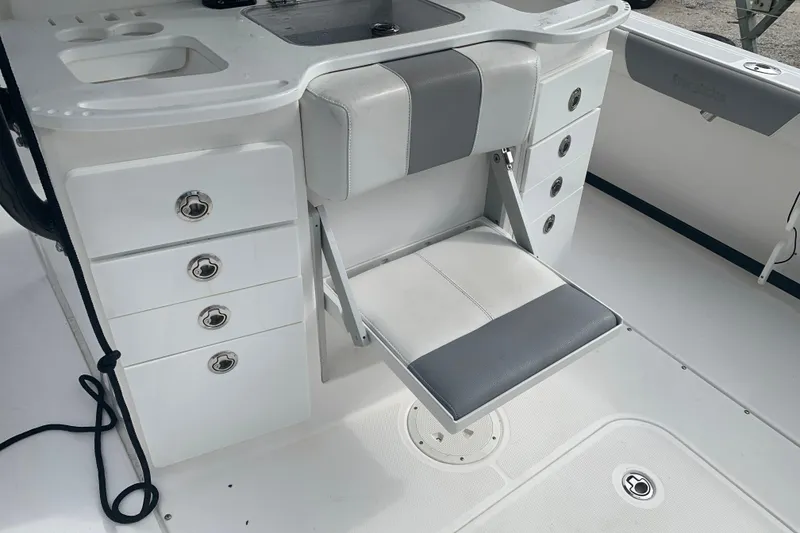 Slide: The Image of 2018 Everglades 355 Center Console boat interior with foldable seat and storage drawers. - 13