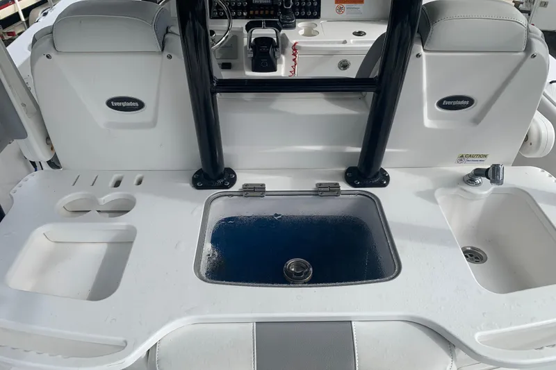 Slide: The Image of 2018 Everglades 355 Center Console boat interior with sink and storage compartments. - 14