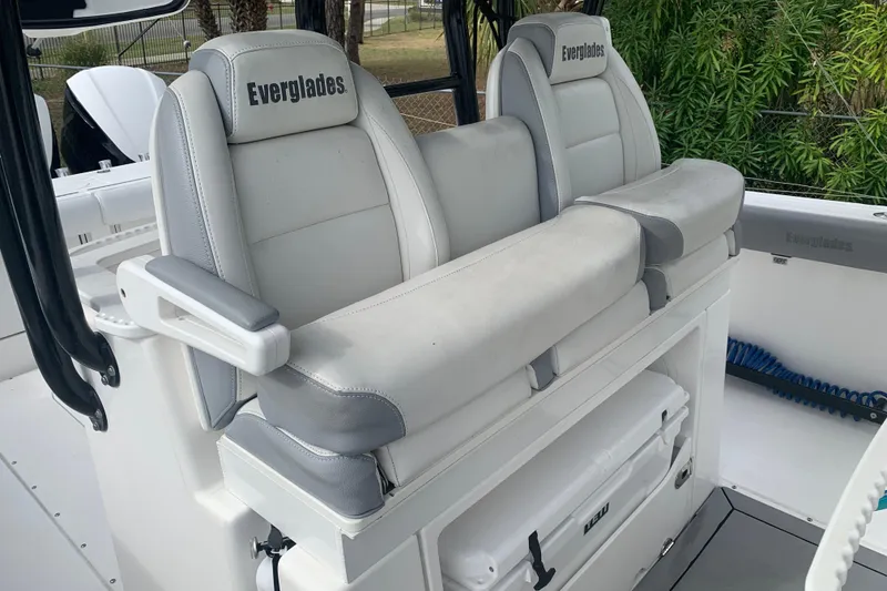 Slide: The Image of 2018 Everglades 355 Center Console boat seats, featuring white and gray upholstery. - 15