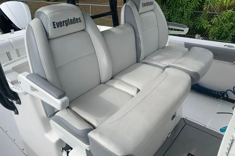 Slide: The Image of 2018 Everglades 355 Center Console boat seats, featuring gray upholstery and armrests. - 16