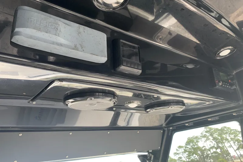 Slide: The Image of 2018 Everglades 355 Center Console interior with speakers and electronic controls. - 18
