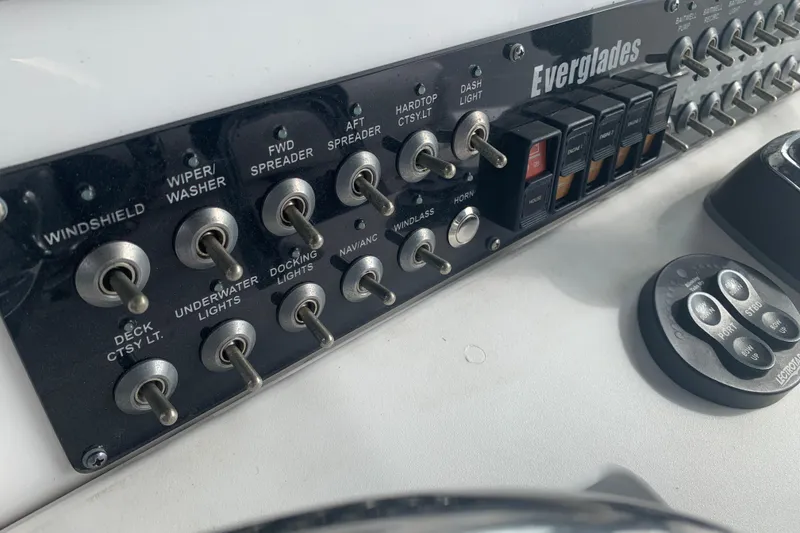 Slide: The Image of Control panel of a 2018 Everglades 355 Center Console boat with various switches. - 24