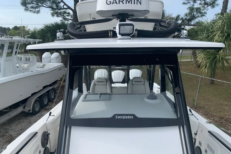 Slide: The Image of 2018 Everglades 355 Center Console boat with Garmin equipment, parked outdoors. - 29