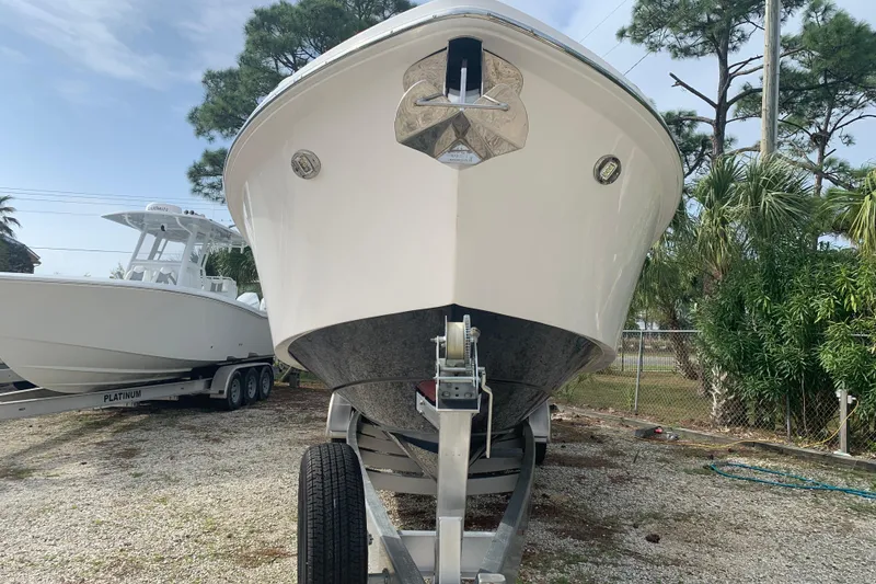 Slide: The Image of 2018 Everglades 355 Center Console boat on trailer, parked outdoors. - 33