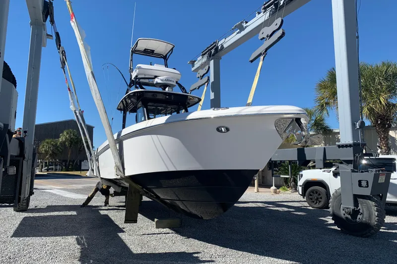 Slide: The Image of 2018 Everglades 355 Center Console boat on lift, sunny day, palm trees in background. - 6