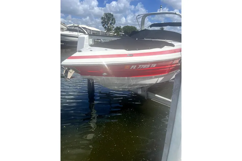 The Image of 2022 Crownline 270 XSS boat docked on water under a sunny sky. - 0