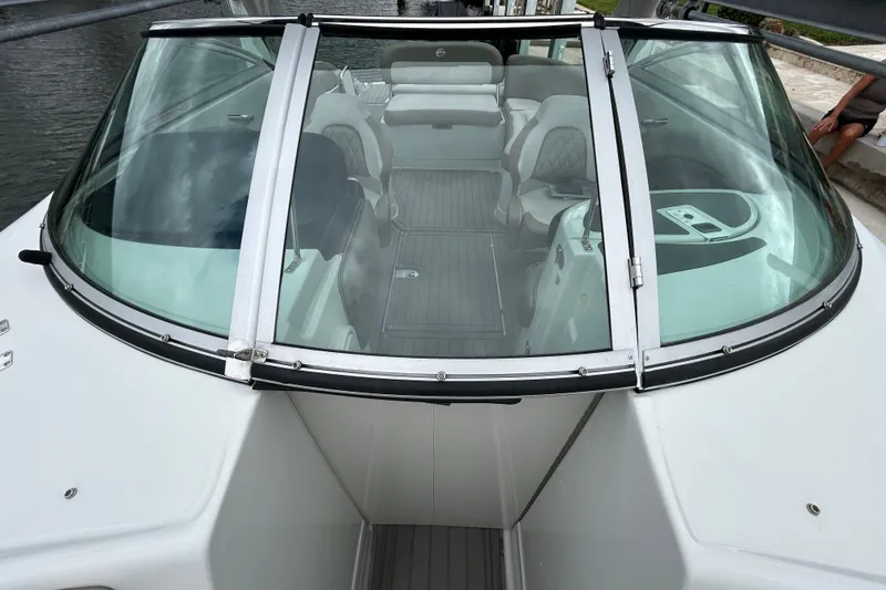Slide: The Image of Bow of 2022 Crownline 270 XSS boat with storage compartment and water view. - 104