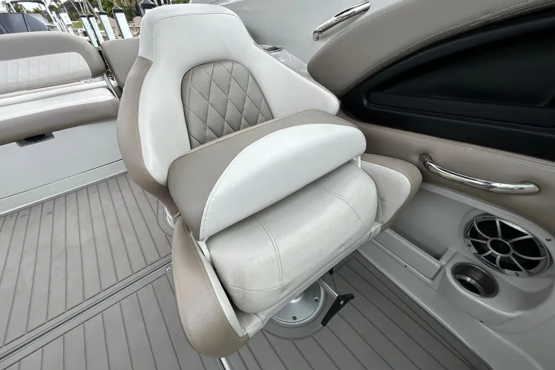 Slide: The Image of 2022 Crownline 270 XSS boat interior with open storage compartment and cushioned seating. - 108