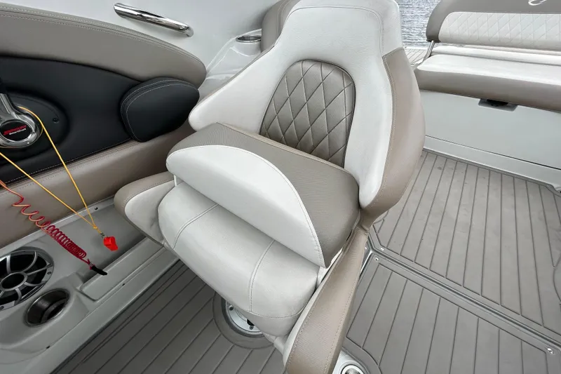 Slide: The Image of Luxurious seating in 2022 Crownline 270 XSS boat, featuring elegant upholstery and speaker system. - 110