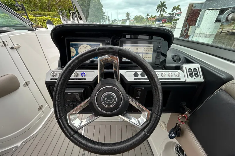 Slide: The Image of 2022 Crownline 270 XSS boat interior with cushioned seating and cup holders. - 111