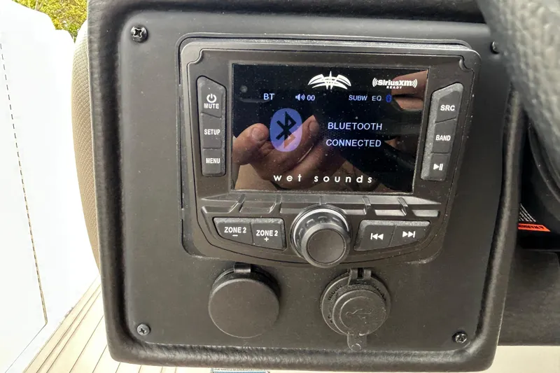 Slide: The Image of Interior storage compartment of 2022 Crownline 270 XSS boat with cup holders. - 113