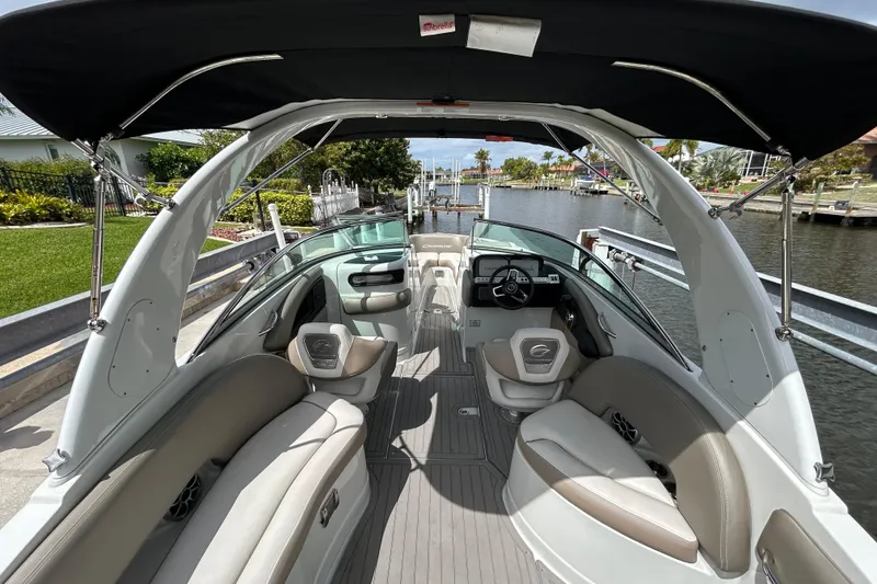 Slide: The Image of Interior of a 2022 Crownline 270 XSS boat with modern seating and steering console. - 21