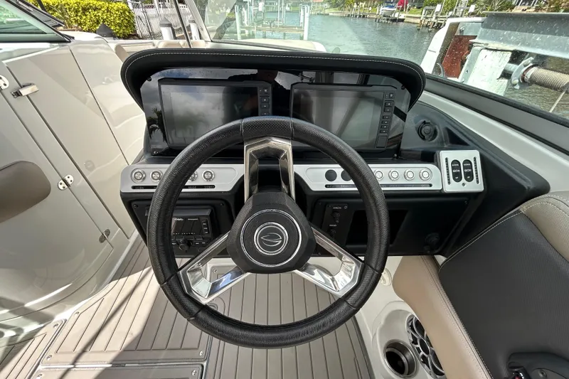 Slide: The Image of 2022 Crownline 270 XSS boat interior with luxurious seating and cup holders. - 28