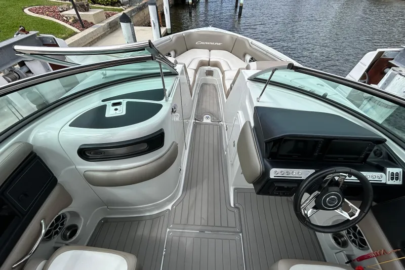 Slide: The Image of 2022 Crownline 270 XSS boat interior with cushioned seating near dock. - 30