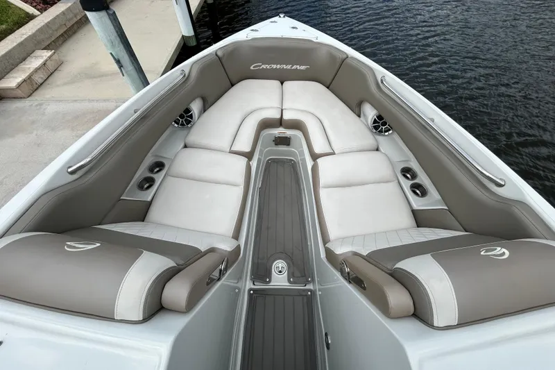 Slide: The Image of 2022 Crownline 270 XSS boat with luxurious seating, docked by a canal. - 32
