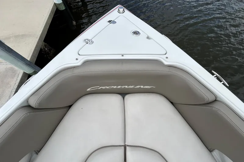 Slide: The Image of 2022 Crownline 270 XSS boat docked, featuring luxurious seating and sleek design. - 34