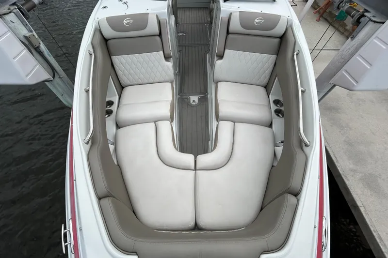 Slide: The Image of 2022 Crownline 270 XSS boat interior with seating and windshield, docked by the water. - 35