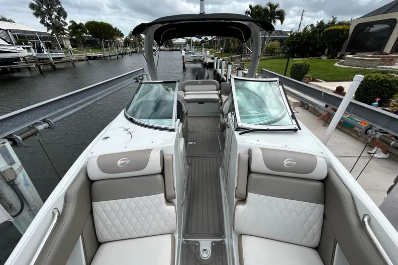 Slide: The Image of 2022 Crownline 270 XSS boat interior with luxurious seating and waterfront view. - 38