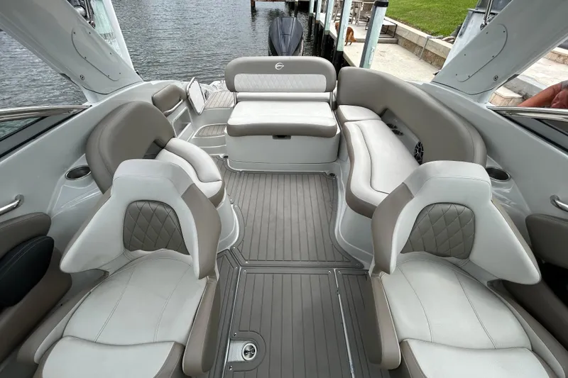 Slide: The Image of 2022 Crownline 270 XSS boat interior with cushioned seating and outboard motor. - 44