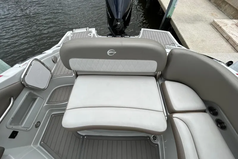 Slide: The Image of 2022 Crownline 270 XSS boat with powerful outboard motor docked by a canal. - 47