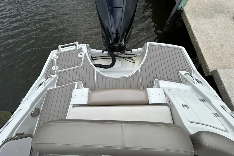 Slide: The Image of 2022 Crownline 270 XSS boat ladder on deck by water. - 49